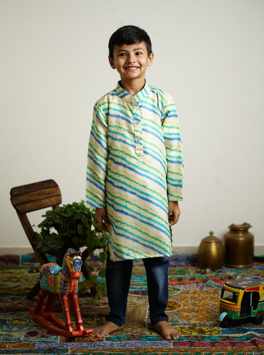 Off white leheriya kotta fabric stand collar long kurta with wooden buttons.Kurtas with collar or Angrakha pattern teamed with salwar are the best choice for any festive occasion for boys.They are Trendy, Easy to wear and comfortable to carry.
