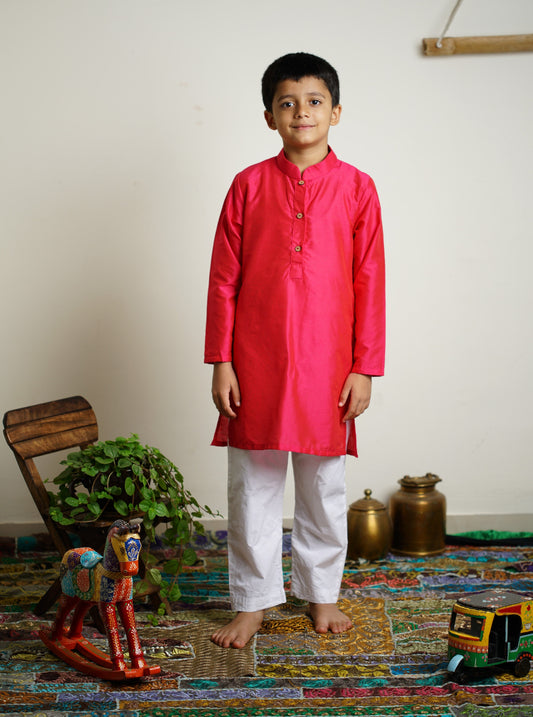 Fuchsia (dark pink) cotton silk stand collar long kurta with wooden buttons.Kurtas with collar or Angrakha pattern teamed with salwar are the best choice for any festive occasion for boys.They are Trendy, Easy to wear and comfortable to carry.