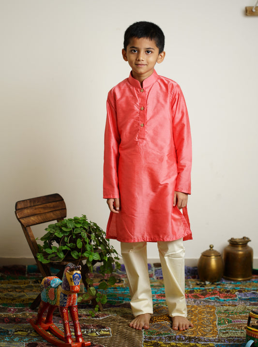 Carrot Pink cotton silk stand collar long kurta with wooden buttons.Kurtas with collar or Angrakha pattern teamed with salwar are the best choice for any festive occasion for boys.They are Trendy, Easy to wear and comfortable to carry.