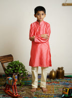 Carrot Pink cotton silk stand collar long kurta with wooden buttons.Kurtas with collar or Angrakha pattern teamed with salwar are the best choice for any festive occasion for boys.They are Trendy, Easy to wear and comfortable to carry.