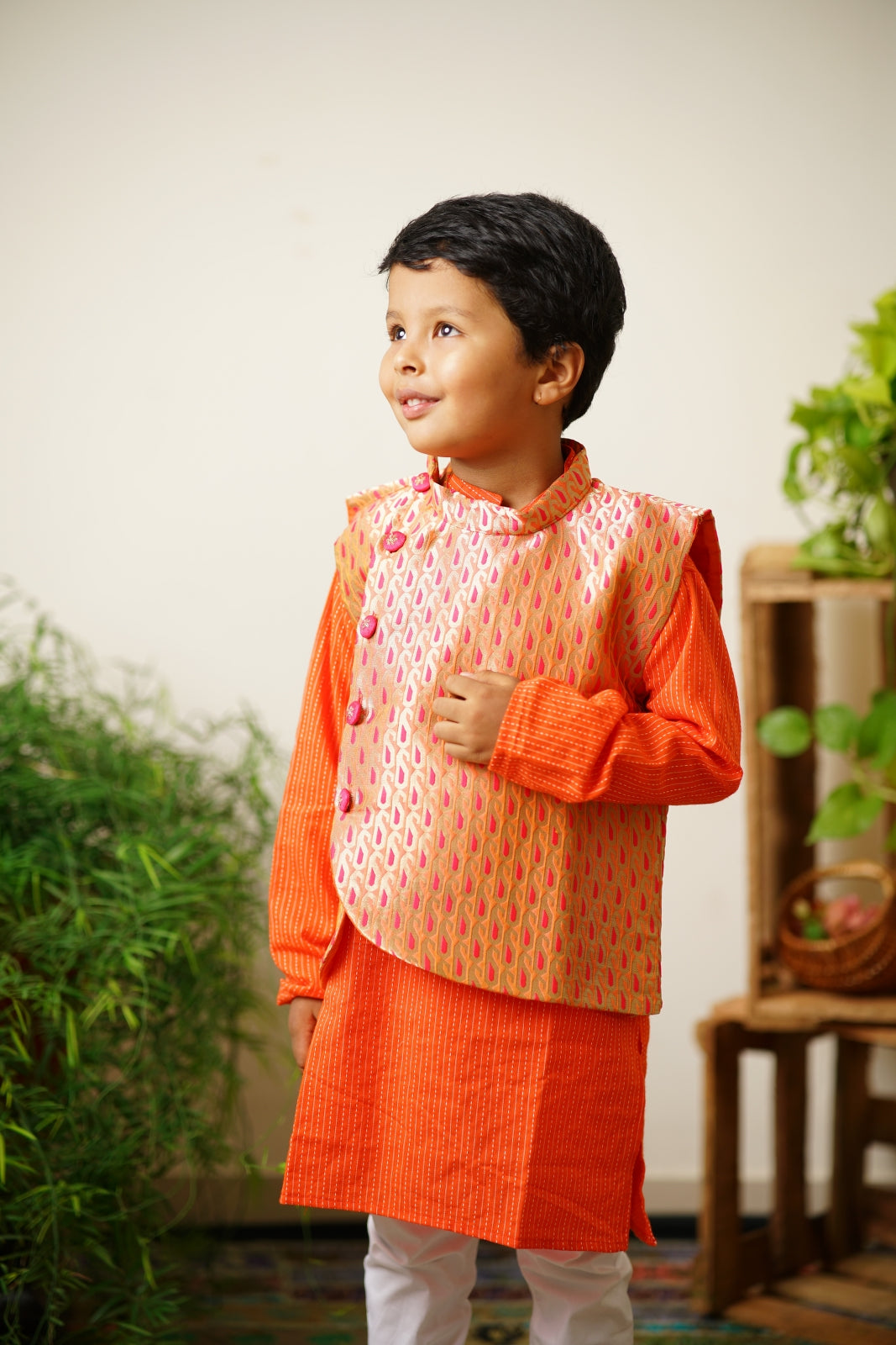 Parsley patterned orange & pink brocade jacket.Cotton lining from inside avoid sweating but give warmth.Statement embellished buttons add royal charm to these jackets. Team these with any plain colored kurta or satin shirt for best festive look!