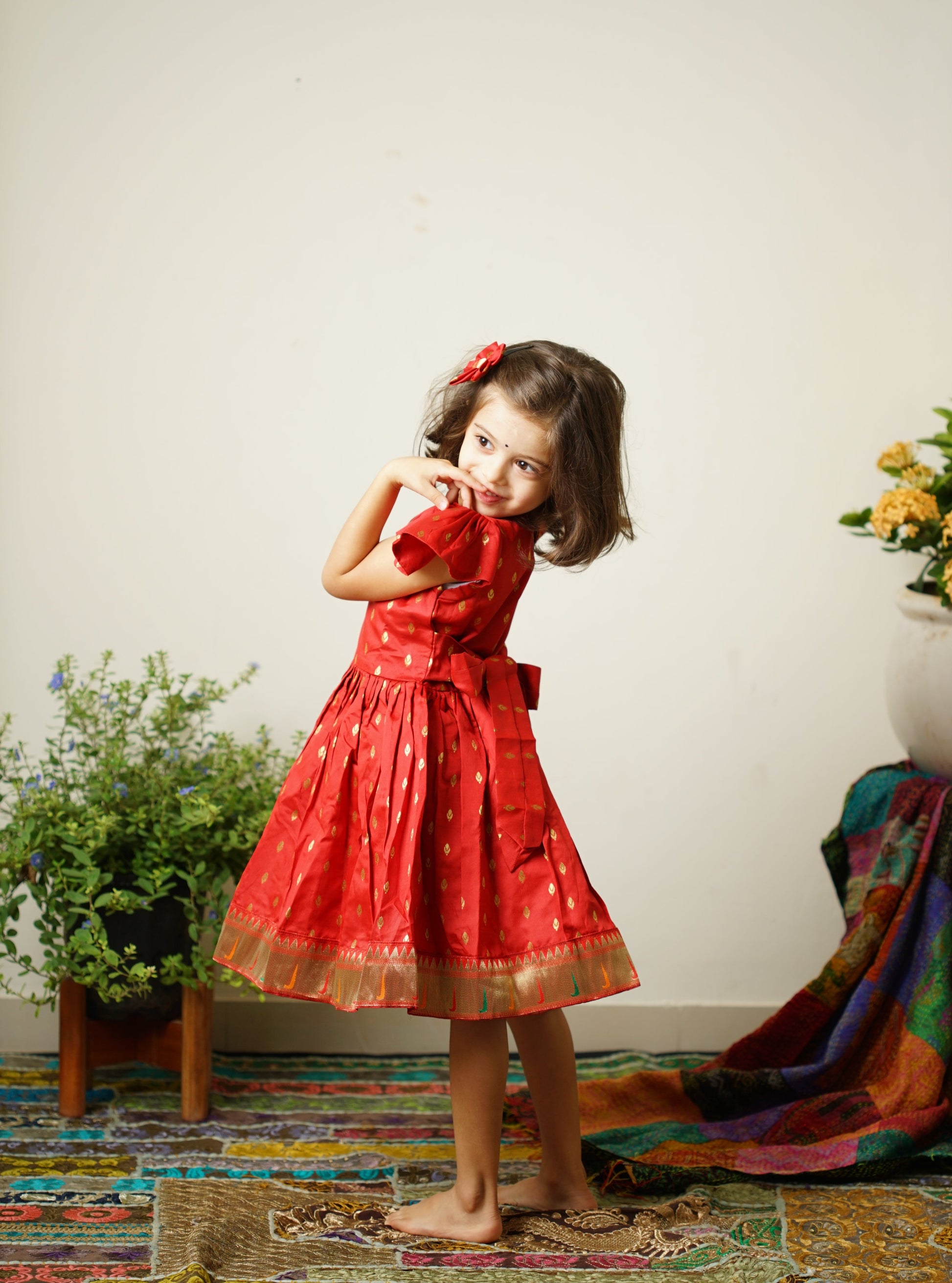 Red taffeta silk cap sleeved frock with paithani border.Let your princess be as comfortable as in her casuals with carefully designed & crafted Comfort Ethnic Wear by Soyara Ethnics.Keep her fashion quotient high with timeless patterns, vibrant combinations and royal textiles.