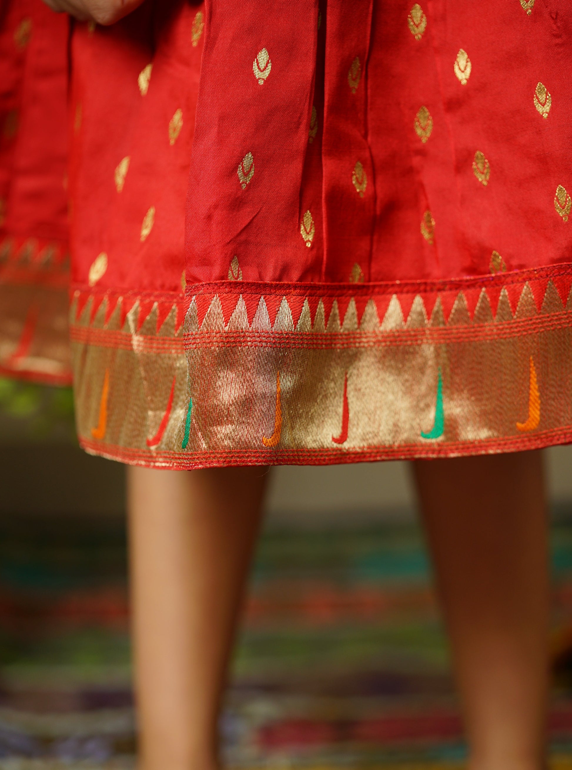 Red taffeta silk cap sleeved frock with paithani border.Let your princess be as comfortable as in her casuals with carefully designed & crafted Comfort Ethnic Wear by Soyara Ethnics.Keep her fashion quotient high with timeless patterns, vibrant combinations and royal textiles.