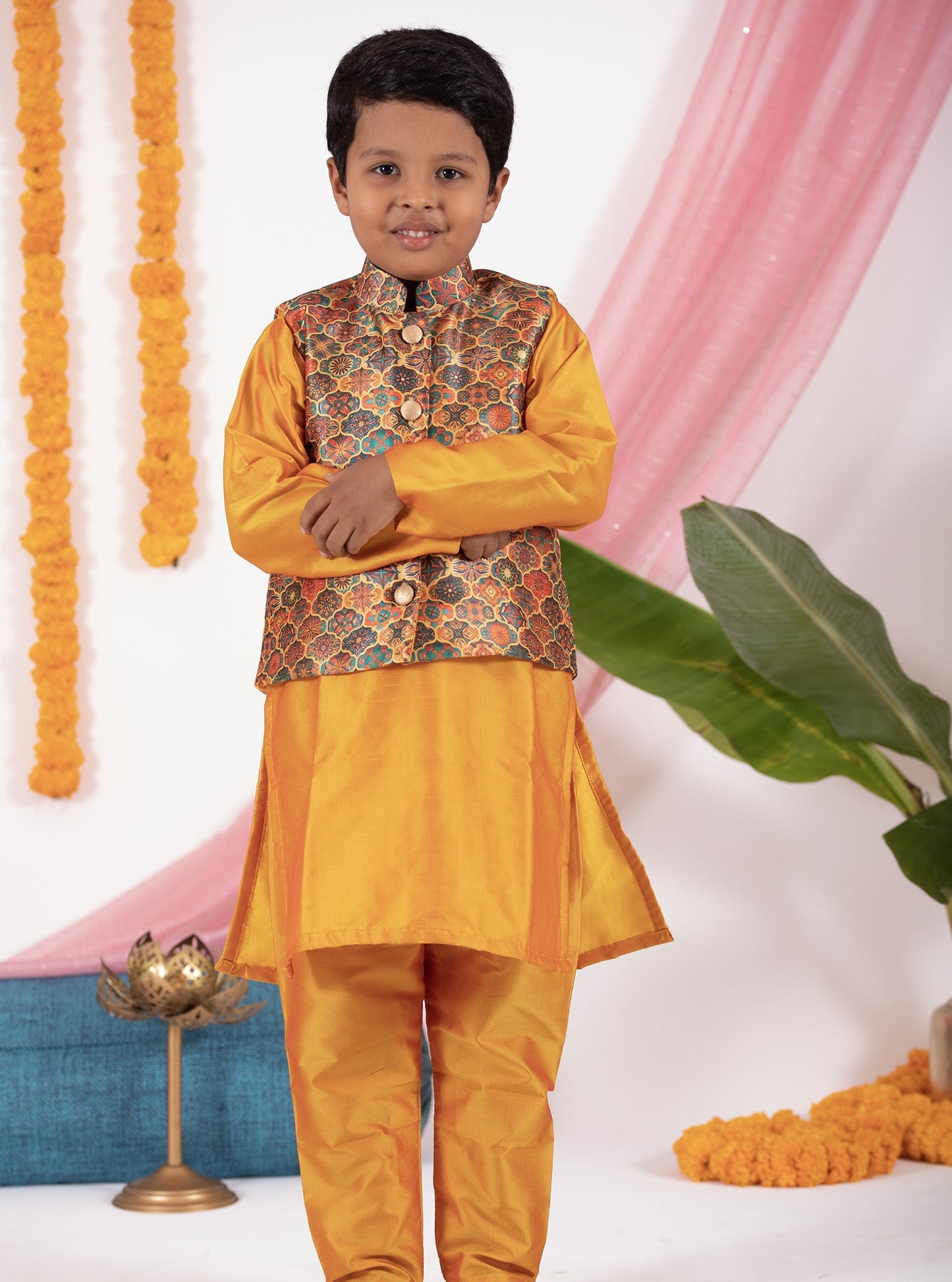 Mango coloured taffeta kurta and salwar set with digital printed silk jacket.Kurtas with collar or Angrakha pattern teamed with salwar are the best choice for any festive occasion for boys. They are Trendy, Easy to wear and comfortable to carry.