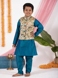 Peacock blue taffeta silk kurta and salwar set with digital printed tussar silk jacket.Kurtas with collar or Angrakha pattern teamed with salwar are the best choice for any festive occasion for boys. They are Trendy, Easy to wear and comfortable to carry.