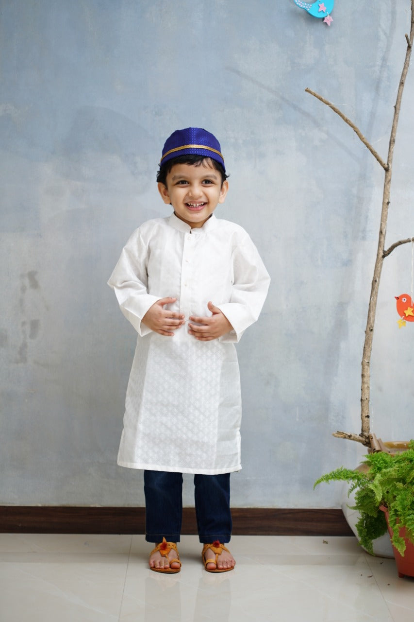 Emboss Silk White colored Stand Color Kurta.Kurtas with collar or Angrakha pattern teamed with salwar are the best choice for any festive occasion for boys.They are Trendy, Easy to wear and comfortable to carry.