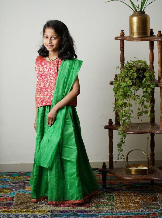 Parrot green chanderi ghagra with carrot pink brocade choli &  parrot green chanderi dupatta.Let your princess be as comfortable as in her casuals with carefully designed & crafted Comfort Ethnic Wear by Soyara Ethnics.Keep her fashion quotient high with timeless patterns, vibrant combinations and royal textiles. 