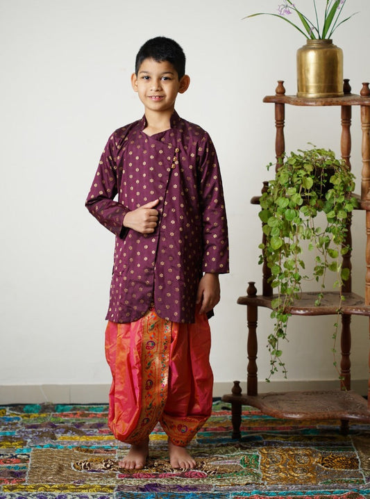 Wine coloured brocade silk short kurta with Side overlap pattern and golden loops.Kurtas with collar or Angrakha pattern teamed with salwar are the best choice for any festive occasion for boys.They are Trendy, Easy to wear and comfortable to carry.