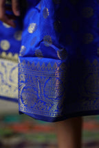 Royal blue banarasi brocade dress with woven jari borders for Girls.Let your princess be as comfortable as in her casuals with carefully designed & crafted Comfort Ethnic Wear by Soyara Ethnics.Keep her fashion quotient high with timeless patterns, vibrant combinations and royal textiles.