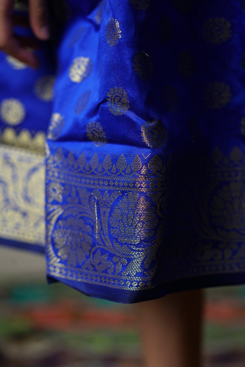 Royal blue banarasi brocade dress with woven jari borders for Girls.Let your princess be as comfortable as in her casuals with carefully designed & crafted Comfort Ethnic Wear by Soyara Ethnics.Keep her fashion quotient high with timeless patterns, vibrant combinations and royal textiles.